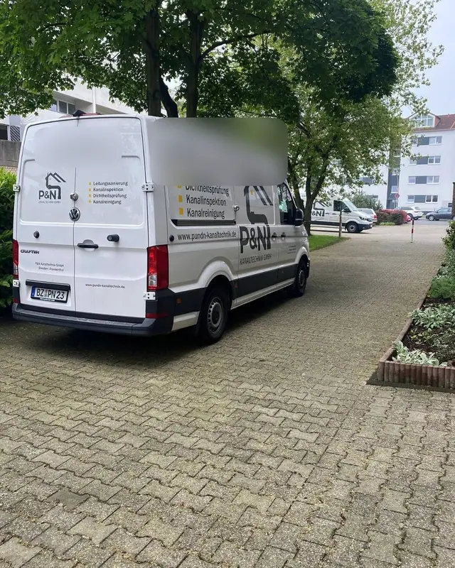 Einsatzfahrzeug des Partnerbetriebs P&N Kanaltechnik vor einer Wohnanlage
